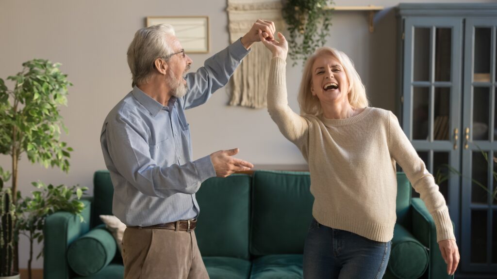 Old Couple Dancing In Living Room